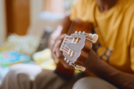 Beginner guitarist learning to play easy songs using guitar tabs with the Simply Guitar app
